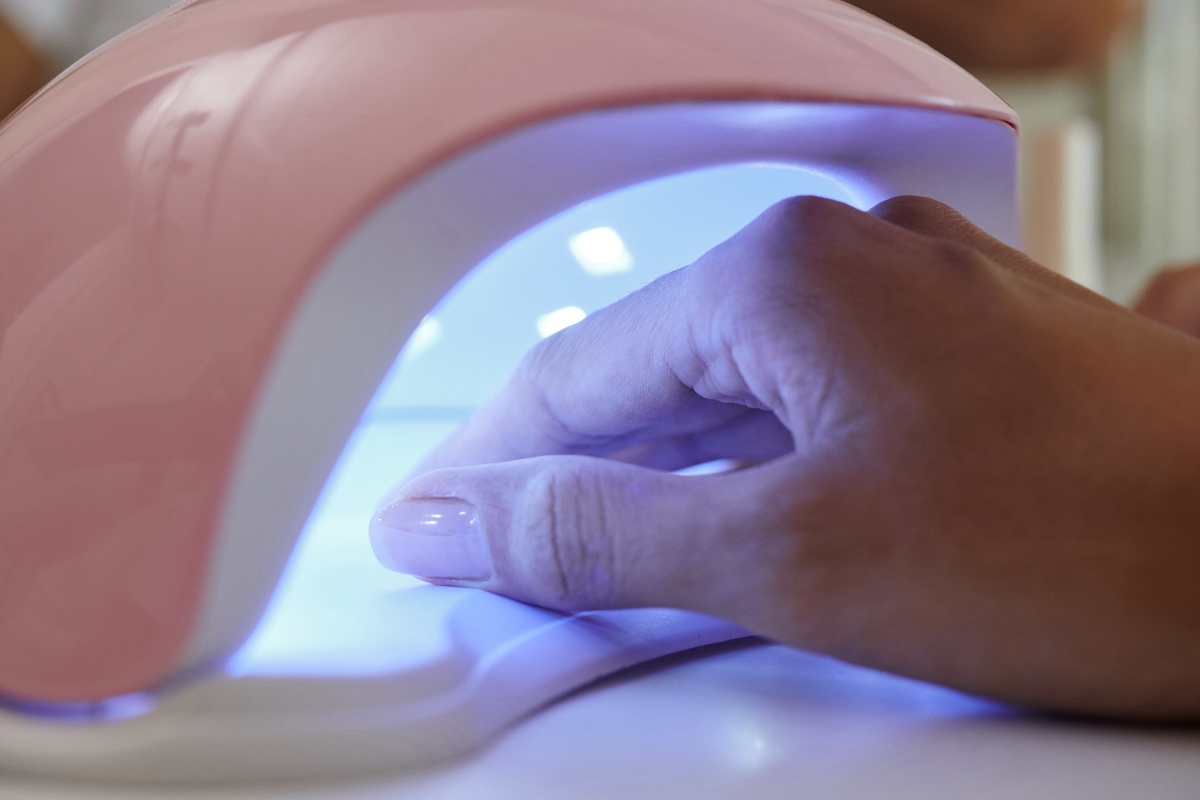 Main d'une femme dans une lampe UV