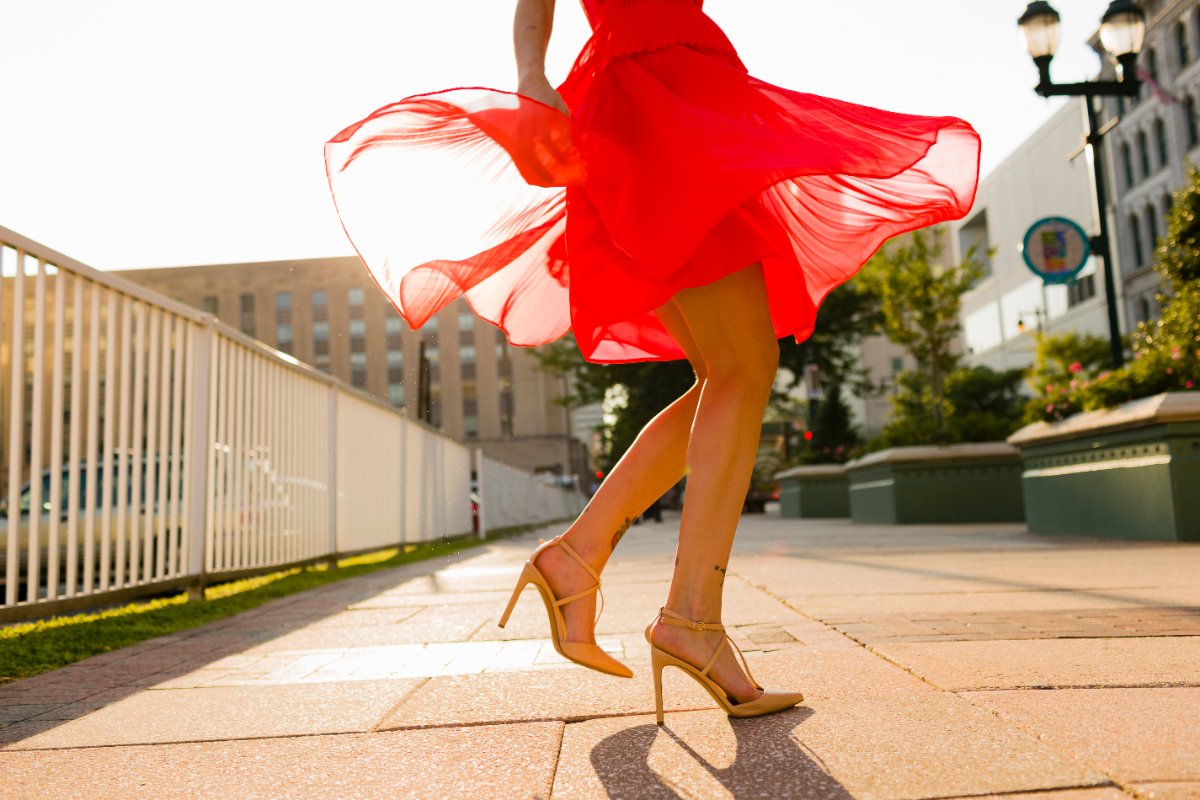 Une femme en robe rouge tournant sur une allée